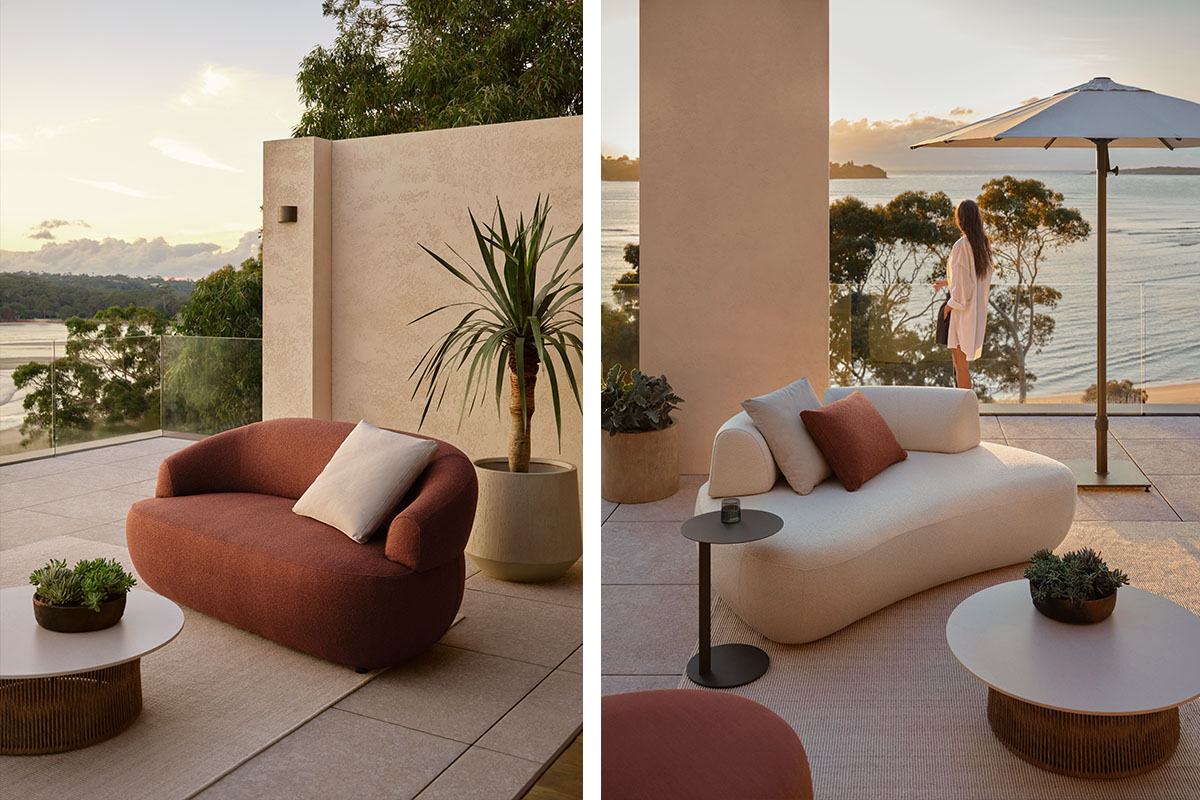 Cream and russet curved outdoor sofas in an earthy colour palette, styled in an outdoor living space on a coastal balcony at sunset.