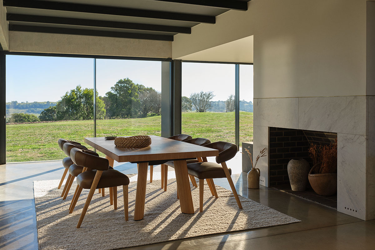 Extension dining table in a light oak timber finish seating six and extending to ten. Modern setting with leather dining chairs.