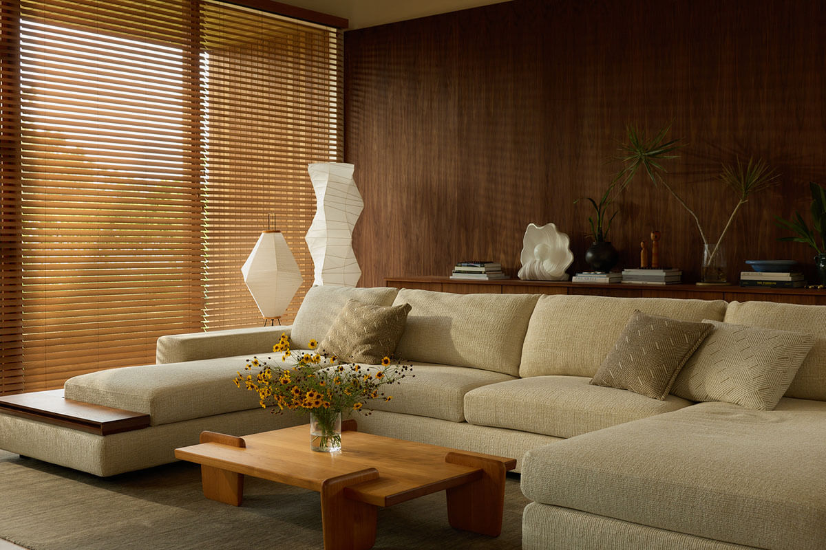 Modular sofa in sand woven fabric, layered cushions in a warm living room (above). Neutral and rust fabric swatches (below).